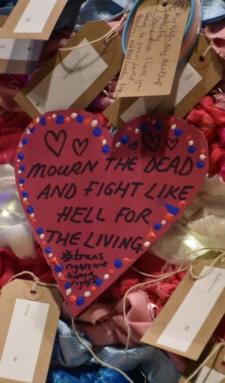 A heart shape note that says 'mourn the dead and fight like hell for the living #transrightsarehumanrights'